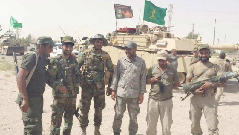 PMF militants pose with an American M1 tank shortly after they captured the tank from ISIS. The fighter on the right is holding an American made AT-4 recoilless anti-tank weapon.